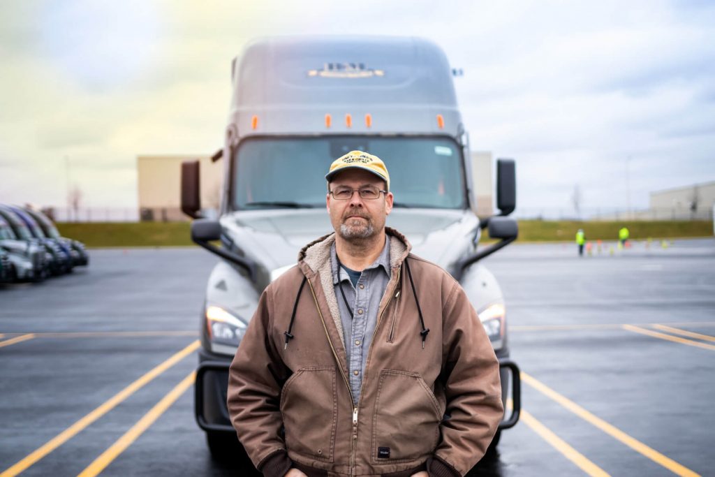 b and m driver standing in front of his semi truck